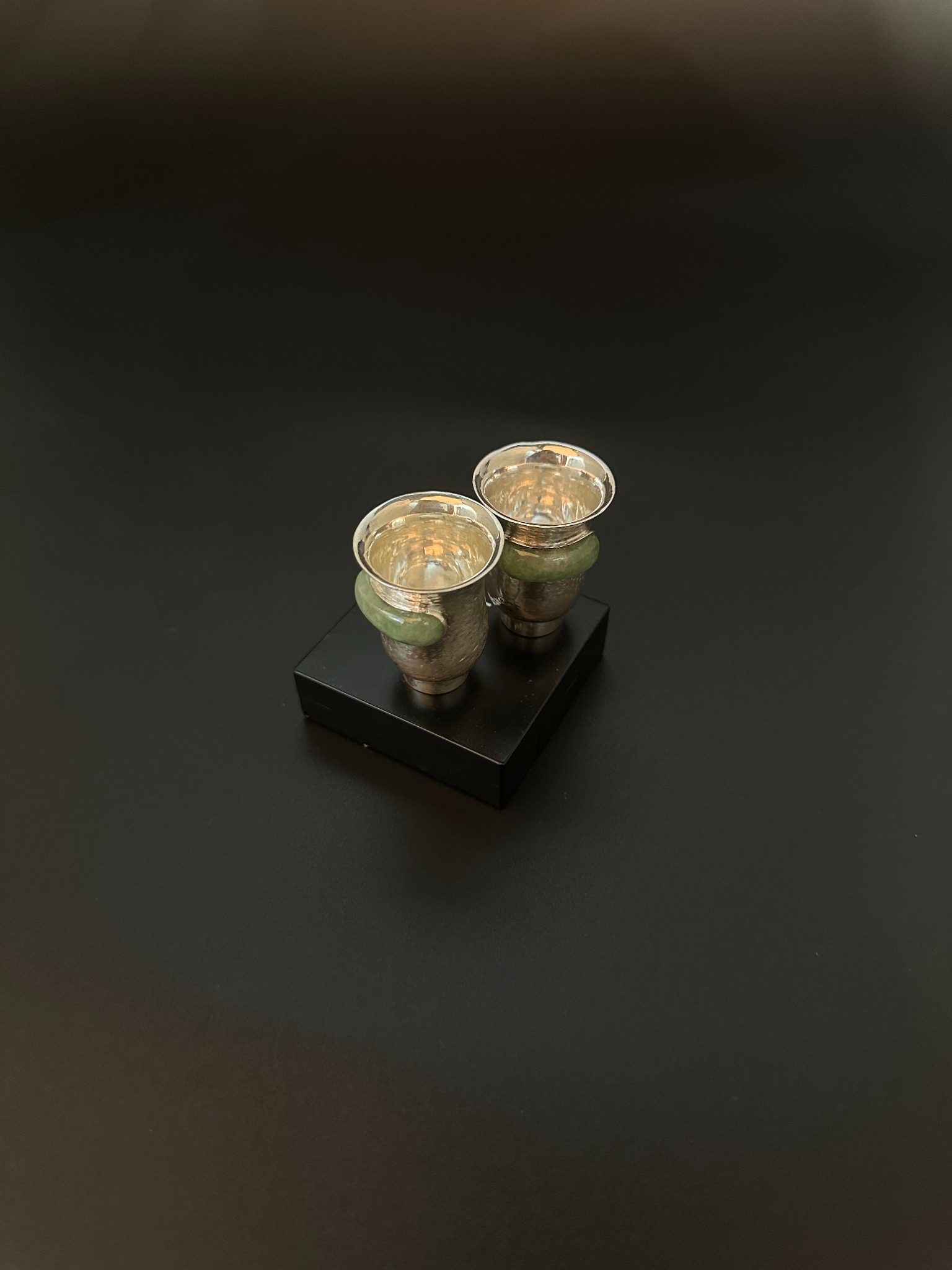 Pair of silver and jade cups viewed from above