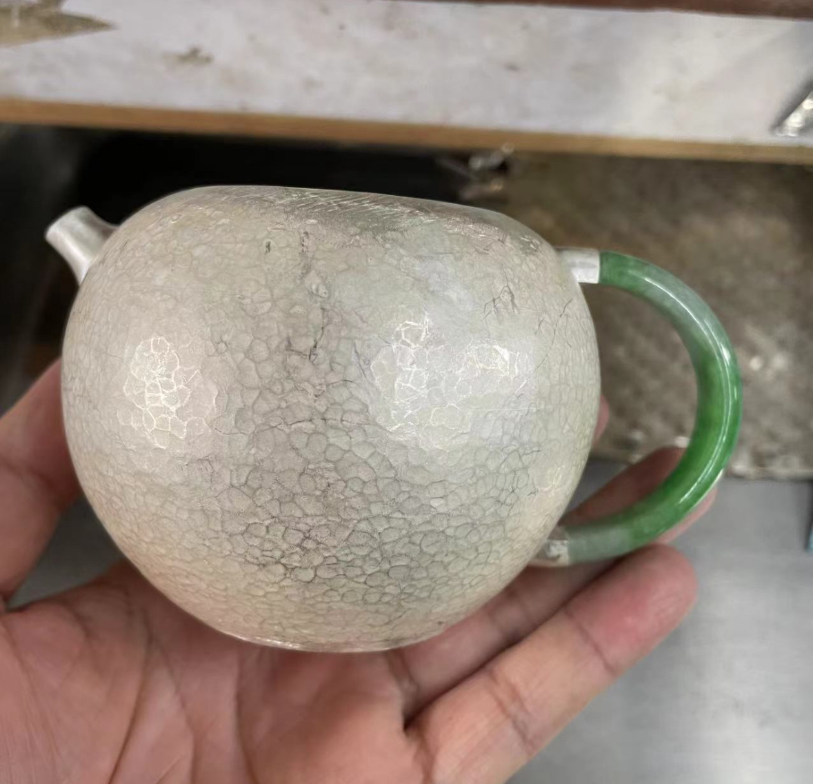 Testing the jade handle against the silver form